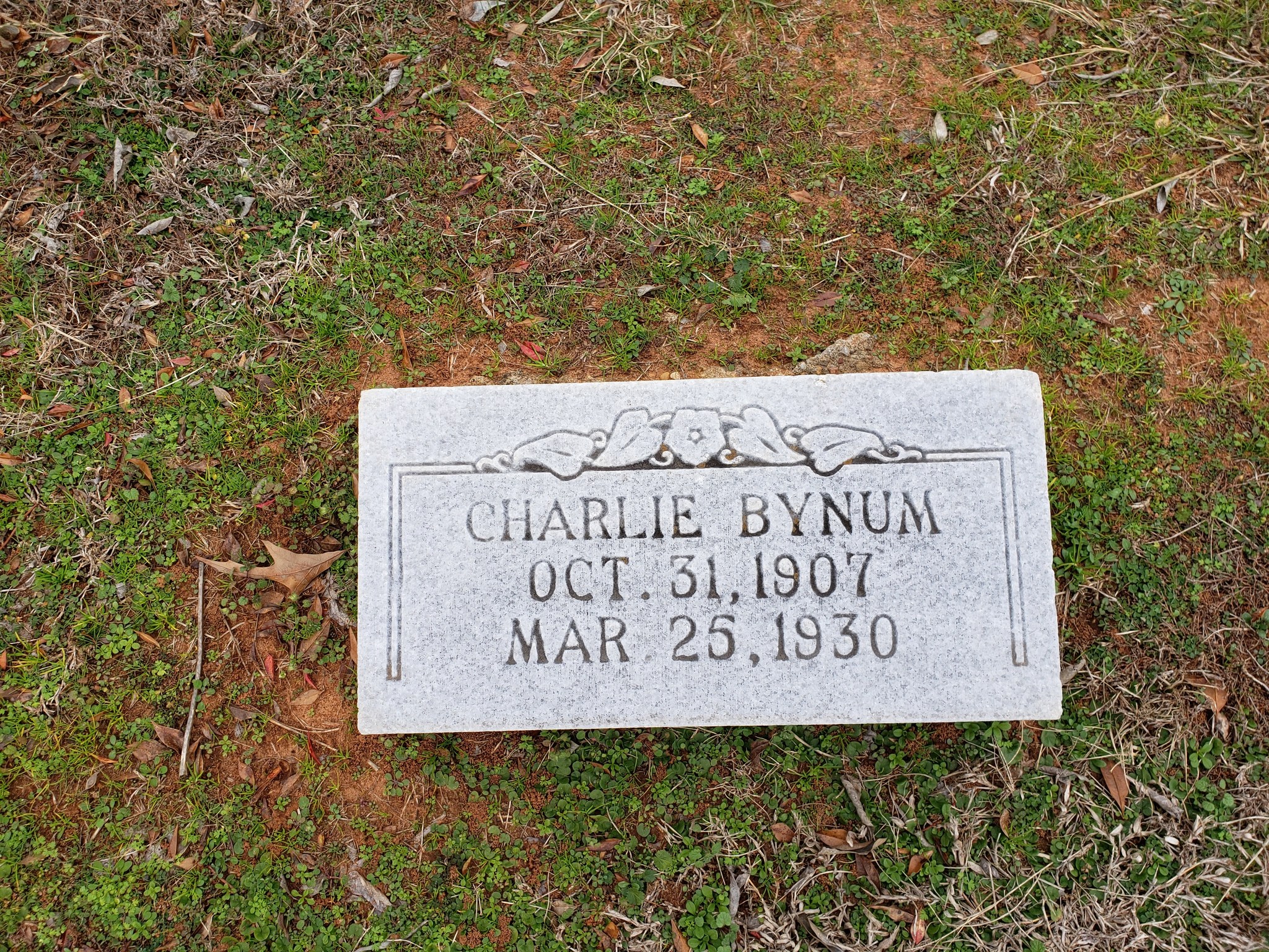 Historic gravestone of Charlie Bynum, October 31, 1907 – March 25, 1930 — representing the genealogical records at Woodlands Cemetery